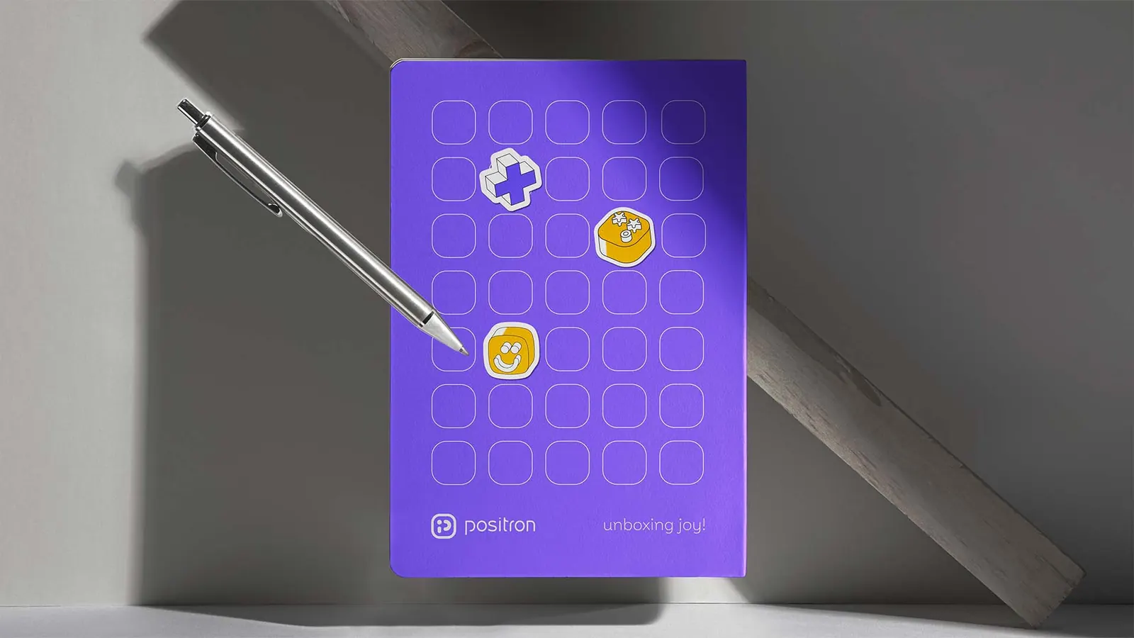 Positron notebook covered in brand stickers