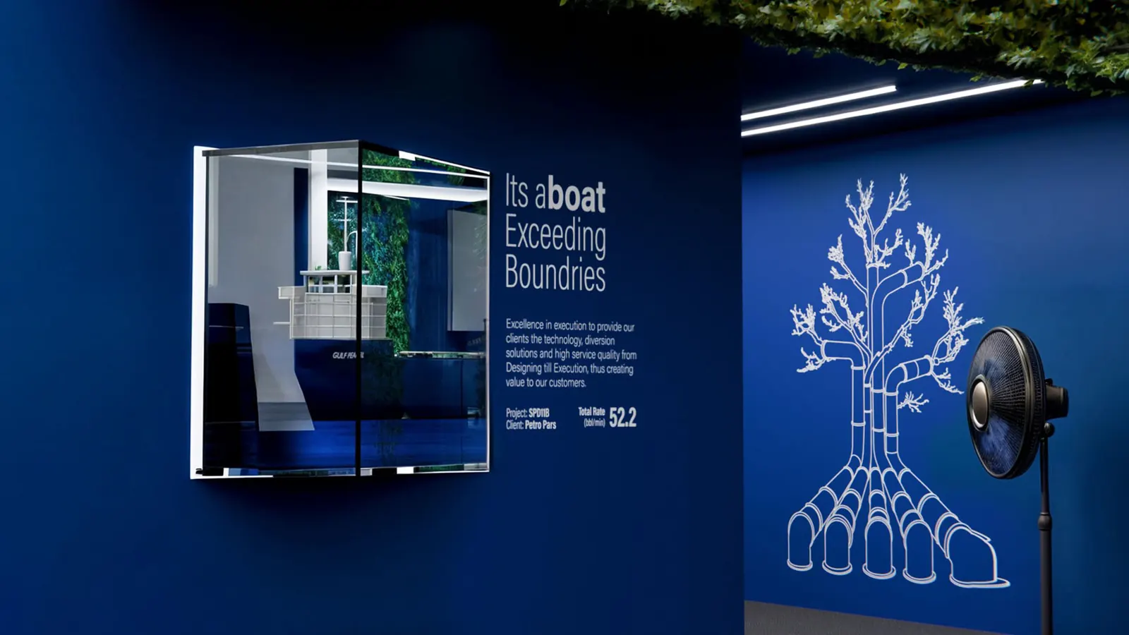 Booth interior wall with a white line-drawn tree on blue